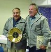 Dave Spirtes holds an award presented to him by Ron Arnberger, Alaska Regional Director (retired).