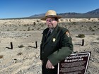 ranger standing near park sign