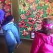 Children look at a collage of poinsettias