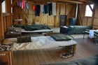 Inside of a barracks at Manzanar showing laundry drying on the line and cots