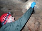scientist collecting sample in cave