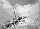 Men at bottom of mountain pass and climbing pass.