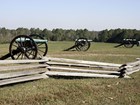 cannons in field with split rail fence