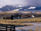 ranch buildings and mountains beyond