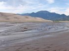 stream, dunes, and mountains