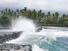 waves breaking on stone wall