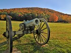 cannon in field with mountain in background