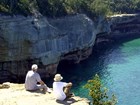 hikers on point overlooking lakeshore and bluffs