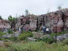 hikers below rock face