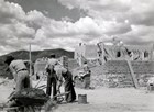 Historic photo of CCC men constructing adobe bricks for building
