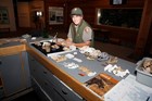 ranger working with series of canine skull models