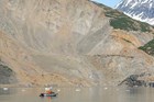 An NPS skiff of researchers is dwarfed by a massive coastal landslide.