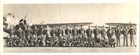 two rows of men in uniforms in front of planes