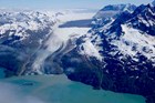 A cruise ship sits in front of a tidewater glacier.