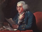 Color portrait of Benjamin Franklin holding papers, and with his chin resting on his thumb.
