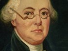 Detail, color portrait of James Wilson showing his face with round-frame spectacles.