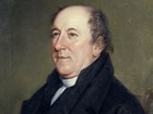 Color head-and-shoulders portrait of Rufus King, showing a balding man in a dark suit.