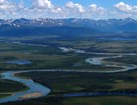Overview of a serpentine river through boreal forest and tundra.