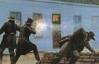Men aiming guns toward building