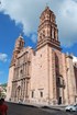 Exterior of elaborate church with bell towers. 