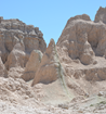a green line runs vertically through a peak of brown badlands rock.