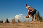 leaping deer dancer with gourds, face covering, ankle rattles