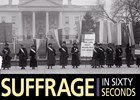 Women wearing sashes standing in front of White House with banners