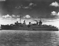 black and white photo of large ship on water, with smaller ships in front of it.