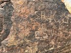 A rock with names etched into it.
