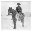 African American soldier on a horse in a dusty landscape