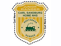 Image of gold badge with words Junior Ranger Carl Sandburg Home NHS