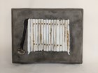 A cast iron piece of art that depicts a radiator