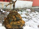 A cast iron head with stem sprouting out of the ground