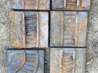 Twelve cast iron squares depicting a series of parallel train tracks