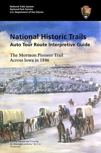The cover of a travel guide that has an illustration of a covered wagon train crossing a snowy area.