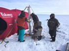 Scientists set up to collect a lake sediment core in the Arctic.