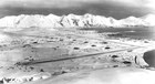 Aerial view of snowy mountains and airstrip