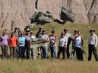 several people stand for a group photo in badlands
