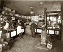 Men standing in a store. 