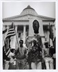Marchers stand in front of the state capitol building in Sacramento.