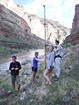 three people posing with equipment in canyon valley