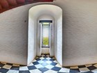 lighthouse window in white brick archway with black-and-white checked floor
