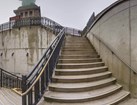 Stone steps leading up to pedestal and base of the Statue of Liberty in fog