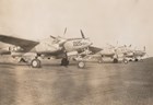 Propeller planes parked on runway. 