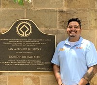 man posing in front of San Antonio Missions sign
