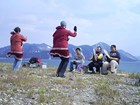 Traditional dancers on the tundra.