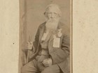 Jordan Noble, at around 87 years of age, poses for a full portrait in civilian clothes. 