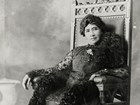 Regal Hawaiian woman in sumptuous beaded gown sits for professional photo