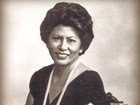 Photo of woman with short curly hair smiling
