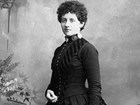 Formal portrait of white woman in black dress with large bustle